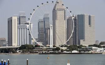 The Singapore Flyer sits againts the highrise of offices and hotel buildings in Singapore on April 8, 2016. / AFP / ROSLAN RAHMAN        (Photo credit should read ROSLAN RAHMAN/AFP via Getty Images)