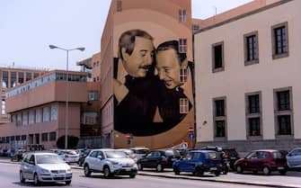 PALERMO, ITALY - AUGUST 8: A large mural, created by Rosk and Loste, two artists from Caltanissetta, which portrays judges Giovanni Falcone and Paolo Borsellino killed by the mafia and reproduces the famous shot of photographer Tony Gentile who sees the two talking to each other smiling on the facade of the Istituto Nautico Gioeni - Trabia in Palermo situation in the area of Cala on August 8, 2019 in Palermo, Italy. (Photo by Stefano Montesi - Corbis/Getty Images)