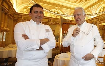 French chef Alain Ducasse (C) poses with kitchen manager Dominique Lory (L) and restaurant manager Michel Lang (R) in the "Louis XV" new dining restaurant in the Hotel de Paris, on May 8, 2015 in Monaco.  AFP PHOTO / VALERY HACHE        (Photo credit should read VALERY HACHE/AFP via Getty Images)