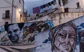 1229266558 ALIANO, BASILICATA, ITALY - OCTOBER 24: Murals with the face of Carlo Levi on October 24, 2020 in Aliano, Italy. Carlo Levi was an Italian painter, writer, activist, anti-fascist, and doctor He is best known for his book Cristo si è fermato a Eboli (Christ Stopped at Eboli), published in 1945, a memoir of his time spent in exile to Aliano, Italy, after being arrested in connection with his political activism with anti-fascist movements, Levi was arrested and exiled to Aliano (Photo by Stefano Montesi - Corbis/Getty Images)