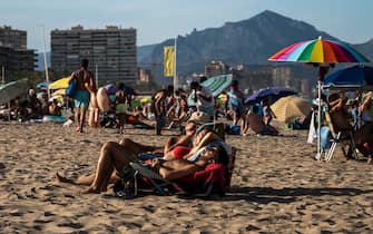 ALICANTE, SPAIN - 2021/08/03: Tourists sunbathing enjoying a day with hot weather in San Juan Beach during summer. (Photo by Marcos del Mazo/LightRocket via Getty Images)