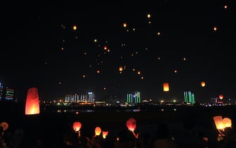 XISHUANGBANNA, CHINA - APRIL 13: (CHINA OUT) Dai people and tourists release sky lanterns (aka Kongming lanterns) at Nine Tower & Twelve Walled to celebrate Dai New Year on April 13, 2016 in Xishuangbanna Dai Autonomous Prefecture, Yunnan Province of China. Dai nationality welcomed the 1378 New Year of Dai calendar. (Photo by VCG)***_***
