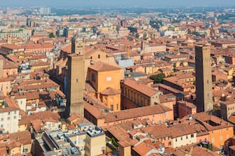 Bologna, Emilia-Romagna, Italy, Overall view of the historic center of the city, Torre Prendiparte on right of Metropolitan cathedral of Saint Peter, The Azzoguido, or Altabella tower on the left. (Photo by: Education Images/Universal Images Group via Getty Images)