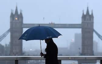 epa06440275 A Commuter walks over London Bridge on what is known as 'Blue Monday' in London, Britain, 15 January 2018. Blue Monday is a name given to a day in January, typically the third Monday of the month. It is said to be the most depressing day of the year.  EPA/ANDY RAIN
