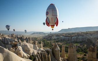 NEVSEHIR, TURKEY - AUGUST 28 : Hot air balloons featuring various figures glide over Goreme district during the 2nd International Cappadocia Hot Air Balloon Festival in Nevsehir, Turkey on August 28, 2021. (Photo by Murat Oner Tas/Anadolu Agency via Getty Images)