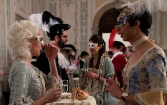 Revellers wearing a mask and a period costume attend a masked ball as part of a dinner at Ridotto salon in Venice during the carnival on February 12, 2022. (Photo by Tiziana FABI / AFP) (Photo by TIZIANA FABI/AFP via Getty Images)