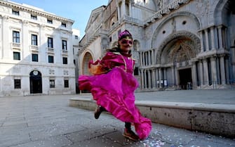 A Venetian girl wearing a carnival mask and costume runs past St. Marks's Basilica in Venice on February 16, 2021, despite the carnival being cancelled due to the Covid-19 pandemic. (Photo by FranÃ§ois-Xavier MARIT / AFP) (Photo by FRANCOIS-XAVIER MARIT/AFP via Getty Images)