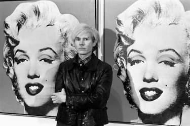 22/02/1987: Died on this day American Pop artist and film maker Andy Warhol  America's pop-art painter and film-maker, Andy Warhol, stands in front of his double portrait of the late Hollywood film star, Marilyn Monroe, at the Tate Gallery, Millbank, at a press preview of his exhibition.   (Photo by PA Images via Getty Images)
