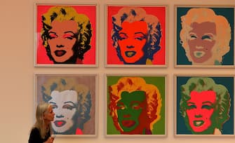 A visitor stands in front of the painting "Marylin" from American artist Andy Warhol during the exhibition "LUDWIG GOES POP" at the Museum Ludwig in Cologne, western Germany, on October 2, 2014. The Museum Ludwig shows never shown works of pop art of various artists from October 2 , 2014 to January 11 , 2015. AFP PHOTO / PATRIK STOLLARZ
RESTRICTED TO EDITORIAL USE - MANDATORY MENTION OF THE ARTIST UPON PUBLICATION, TO ILLUSTRATE THE EVENT AS SPECIFIED IN THE CAPTION        (Photo credit should read PATRIK STOLLARZ/AFP via Getty Images)