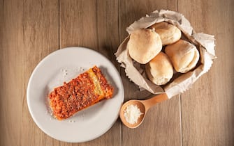 Lasagne al ragÃ¹ with Parmesan and white bread. typical italian dish. Italy. Europe. (Photo by: Enrico Spanu/REDA&CO/Universal Images Group via Getty Images)