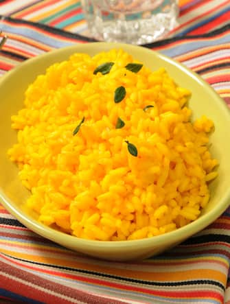 Risotto alla Milanese style, traditional rice with saffron, Milan, Lombardy, Italy, Europe.  (Photo by: Eddy Buttarelli/REDA&CO/Universal Images Group via Getty Images)