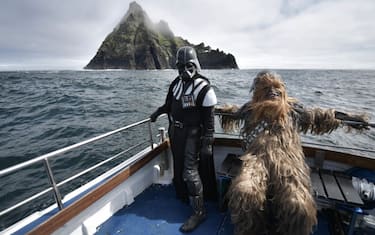 PORTMAGEE, IRELAND - MAY 04: Fans dressed as Darth Vader and Chewbacca take a boat trip to the Skelligs on May 4, 2018 in Portmagee, Ireland. The first ever Star Wars festival is taking place against the backdrop of the famous Skellig Michael island which was used extensively in Episode VII and Episode VIII of the popular science fiction saga. The small fishing village of Portmagee, which is closest to the location, has seen a boom in tourism following the latest films. The vilage will host a Star Wars drive-in and a Star Wars themed Irish dancing competition over the weekend. (Photo by Charles McQuillan/Getty Images)
