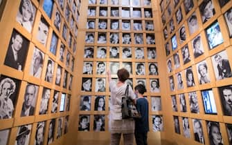 TURIN, ITALY - JUNE 02: People wear protective masks while watching an installation on a wall with photographs of famous actors inside the National Cinema Museum on June 2, 2020 in Turin, Italy. The National Cinema Museum of Turin is housed inside the Mole Antonelliana, a symbol of Turin, the Museum develops spiral upwards, on multiple exhibition levels, with extraordinary collections of the history of cinema from its origins to the present day. Many Italian businesses have been allowed to reopen, after more than two months of a nationwide lockdown meant to curb the spread of Covid-19. (Photo by Stefano Guidi/Getty Images)
