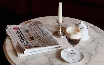 TURIN, ITALY - MAY 28:  A glass of Bicerin is placed on a table inside the Al Bicerin cafe on May 28, 2010 in Turin, Italy. The cafe, situated in front of the entrance of the Santuario della Consolata is renowned for having created the Bicerin, a traditional Torino drink comprising of a mixture of espresso, drinking chocolate and fresh cream carefully layered in a glass, around 1750.  (Photo by Marco Secchi/Getty Images)