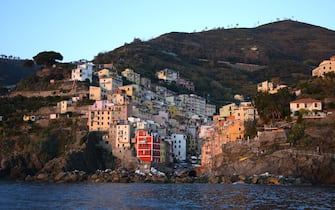 RIOMAGGIORE, ITALY - NOVEMBER 1, 2015: The colorful seaside town of Riomaggiore on Italy's northwest coast is one of five villages which comprise the Cinque Terre region popular with tourists. The string of centuries-old villages on the rugged Italian Riviera coastline, and the surrounding hillsides, are all part of the Cinque Terre National Park and is a UNESCO World Heritage site. (Photo by Robert Alexander/Getty Images)