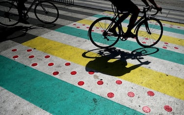 COPENHAGEN, DENMARK - JUNE 29: People cross the road at a crosswalk decorated with the colors of the Tour de France on June 29, 2022 ahead of Tour de France held in Copenhagen, Denmark. (Photo by Sergei Gapon/Anadolu Agency via Getty Images)