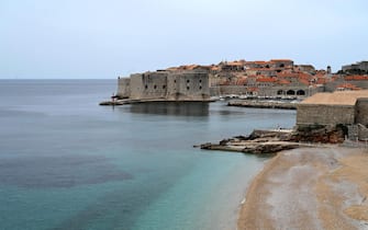 This picture taken on May 17, 2020, shows a general view of  the old town of the city of Dubrovnik, on the Adriatic coast of Croatia. - Less than two months after detecting its first infection, Montenegro is the first country in Europe to declare itself coronavirus-free, a success story the tiny country hopes will lure tourists to its dazzling Adriatic coast this summer. Tourism operators have already seized the opportunity to brand Montenegro as "Europe's First COVID-19 Free Country" in videos promoting its stunning natural beauty, with beaches snaking along the south and rugged mountains in the north. Up the coast, tourism powerhouse Croatia is also hoping to capitalise on its relatively low virus numbers to salvage the 2020 season. (Photo by DENIS LOVROVIC / AFP) (Photo by DENIS LOVROVIC/AFP via Getty Images)
