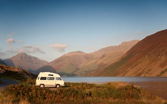 Campervan parked up on the shore of lake Wast water, one of the lakes forming the Lake District National Park.