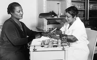 A'Lelia Walker, daughter of Madame C. J. Walker, gets a manicure at one of her mother's beauty shops. Madame C. J. Walker made a fortune from her chain of beauty shops which her daughter has inherited as well as the business. (Photo by George Rinhart/Corbis via Getty Images)
