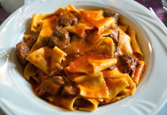 Pappardelle with boar ragu. Tuscan typical recipe of italian pasta.