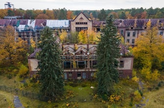 25 October 2021, Brandenburg, Beelitz: The surgery building on the site of the former pulmonary sanatoriums in Beelitz-HeilstÃ¤tten. The 320-metre-long tree-top walk is located on the site. From the steel and wooden construction above the treetops, visitors can view the listed buildings and the park. Photo: Monika Skolimowska/dpa-Zentralbild/dpa (Photo by Monika Skolimowska/picture alliance via Getty Images)