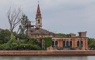 VENICE, ITALY  MAY 2: A general view of the 19th century Venetian geriatric hospital is seen on May 2, 2014 in Poveglia island in the Venice lagoon, Italy. Poveglia island, a 19th century Venetian geriatric hospital, has been put up for sale by Italy's public property agency. A resident's association "Poveglia per tutti" (Poveglia for all) is trying to buy it and give it back to the community. (Photo By Marco Di Lauro/Getty Images)