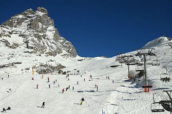 Tourists ski in the ski runs under the Matterhorn mount (Monte Cervino) in the alpine ski resort of Breuil-Cervinia, northwestern Italy, on December 31, 2021. (Photo by Vincenzo PINTO / AFP) (Photo by VINCENZO PINTO/AFP via Getty Images)