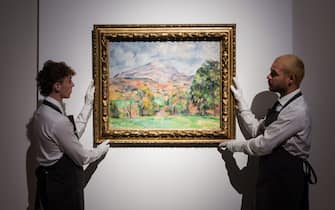 LONDON, UNITED KINGDOM - OCTOBER 14: Art handlers hold a painting titled 'La montagne Sainte-Victoire' by Paul Cezanne (estimate on request: in excess of $120,000,000) during a photo call to present the highlights from the estate of the philanthropist and co-founder of Microsoft, Paul G. Allen in London, United Kingdom on October 14, 2022. The collection of over 150 masterpieces, valued in excess of $1 Billion, will be offered at an auction on 9 and 10 November at Rockefeller Center in New York, with all proceeds dedicated to philanthropic causes. (Photo by Wiktor Szymanowicz/Anadolu Agency via Getty Images)