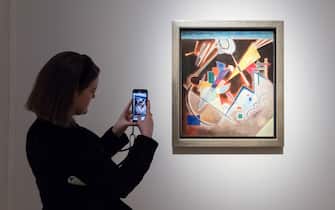 LONDON, UNITED KINGDOM - OCTOBER 14: A staff member takes a picture of a painting titled 'Tiefes Braun' by Wassily Kandinsky (estimate: $10,000,000-15,000,000) during a photo call to present the highlights from the estate of the philanthropist and co-founder of Microsoft, Paul G. Allen in London, United Kingdom on October 14, 2022. The collection of over 150 masterpieces, valued in excess of $1 Billion, will be offered at an auction on 9 and 10 November at Rockefeller Center in New York, with all proceeds dedicated to philanthropic causes. (Photo by Wiktor Szymanowicz/Anadolu Agency via Getty Images)