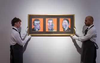 LONDON, UNITED KINGDOM - OCTOBER 14: Art handlers hold a painting titled 'Three Studies for Self-Portrait' by Francis Bacon (estimate on request: in excess of $25,000,000) during a photo call to present the highlights from the estate of the philanthropist and co-founder of Microsoft, Paul G. Allen in London, United Kingdom on October 14, 2022. The collection of over 150 masterpieces, valued in excess of $1 Billion, will be offered at an auction on 9 and 10 November at Rockefeller Center in New York, with all proceeds dedicated to philanthropic causes. (Photo by Wiktor Szymanowicz/Anadolu Agency via Getty Images)
