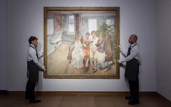 LONDON, UNITED KINGDOM - OCTOBER 14: Art handlers hold a painting titled 'Large Interior, W11 (after Watteau)' by Lucian Freud (estimate on request: in excess of $75,000,000) during a photo call to present the highlights from the estate of the philanthropist and co-founder of Microsoft, Paul G. Allen in London, United Kingdom on October 14, 2022. The collection of over 150 masterpieces, valued in excess of $1 Billion, will be offered at an auction on 9 and 10 November at Rockefeller Center in New York, with all proceeds dedicated to philanthropic causes. (Photo by Wiktor Szymanowicz/Anadolu Agency via Getty Images)