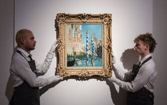 LONDON, UNITED KINGDOM - OCTOBER 14: Art handlers hold a painting titled 'Le Grand Canal a Venise' by Edouard Manet (estimate on request: in excess of $50,000,000) during a photo call to present the highlights from the estate of the philanthropist and co-founder of Microsoft, Paul G. Allen in London, United Kingdom on October 14, 2022. The collection of over 150 masterpieces, valued in excess of $1 Billion, will be offered at an auction on 9 and 10 November at Rockefeller Center in New York, with all proceeds dedicated to philanthropic causes. (Photo by Wiktor Szymanowicz/Anadolu Agency via Getty Images)