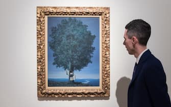LONDON, UNITED KINGDOM - OCTOBER 14: A visitor looks at a painting titled 'La voix du sang' by Rene Magritte (estimate: $12,000,000-18,000,000) during a photo call to present the highlights from the estate of the philanthropist and co-founder of Microsoft, Paul G. Allen in London, United Kingdom on October 14, 2022. The collection of over 150 masterpieces, valued in excess of $1 Billion, will be offered at an auction on 9 and 10 November at Rockefeller Center in New York, with all proceeds dedicated to philanthropic causes. (Photo by Wiktor Szymanowicz/Anadolu Agency via Getty Images)