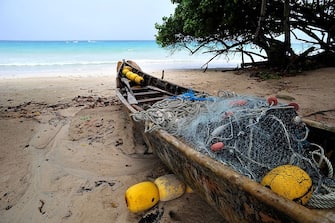 A fisherman's boat in Beau Vallon beach in Mahe on March 5, 2012. AFP PHOTO / ALBERTO PIZZOLI (Photo credit should read ALBERTO PIZZOLI/AFP via Getty Images)