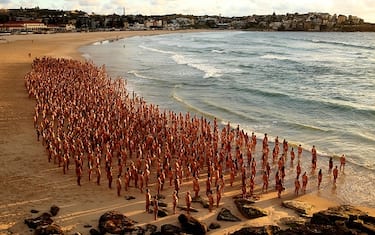 SYDNEY, AUSTRALIA - NOVEMBER 26: (EDITORS NOTE: Image contains nudity.) Members of the public pose at Bondi Beach on November 26, 2022 in Sydney, Australia. US artist and photographer Spencer Tunick created the nude installation using thousands of volunteers posing at sunrise on Bondi Beach, commissioned by charity Skin Check Champions to raise awareness of skin cancer and to coincide with National Skin Cancer Action Week. (Photo by Don Arnold/WireImage)