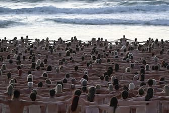 EDITORS NOTE: Graphic content / Participants pose nude during sunrise on Sydney's Bondi Beach for US art photographer Spencer Tunick, to raise awareness for skin cancer, on November 26, 2022. - RESTRICTED TO EDITORIAL USE - MANDATORY MENTION OF THE ARTIST UPON PUBLICATION - TO ILLUSTRATE THE EVENT AS SPECIFIED IN THE CAPTION (Photo by Saeed KHAN / AFP) / RESTRICTED TO EDITORIAL USE - MANDATORY MENTION OF THE ARTIST UPON PUBLICATION - TO ILLUSTRATE THE EVENT AS SPECIFIED IN THE CAPTION / RESTRICTED TO EDITORIAL USE - MANDATORY MENTION OF THE ARTIST UPON PUBLICATION - TO ILLUSTRATE THE EVENT AS SPECIFIED IN THE CAPTION (Photo by SAEED KHAN/AFP via Getty Images)