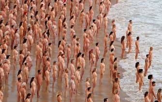 SYDNEY, AUSTRALIA - NOVEMBER 26: (EDITORS NOTE: Image contains nudity.) Members of the public pose at sunrise for photographic artist Spencer Tunick at Bondi Beach on November 26, 2022 in Sydney, Australia. US artist and photographer Spencer Tunick created the nude installation using thousands of volunteers posing at sunrise on Bondi Beach, commissioned by charity Skin Check Champions to raise awareness of skin cancer and to coincide with National Skin Cancer Action Week. (Photo by Lisa Maree Williams/Getty Images)