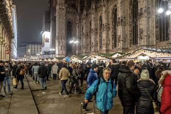 1074137958 MILAN, ITALY - DECEMBER 16: Locals and tourists walking in the Christmas market in Milan on December 16, 2018 in Milan, Italy. (Photo by Awakening/Getty Images)