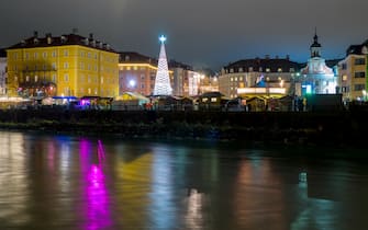 Night shot of Innsbruck Christmas Market in Marktplatz, viewed by Inn river bank