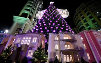 epa09627628 A giant Christmas tree which has been officially lit up with a design symbolizing the reconstruction of the area damaged by the port explosions on 04 August 2020 at the Ashrafieh area in Beirut, Lebanon, 07 December 2021.  EPA/WAEL HAMZEH