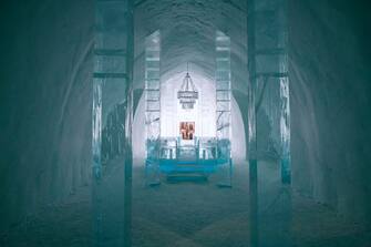 The Main Hall of the Ice Hotel, designed by the artists Jens Thoms Ivarsson, Mats Nilsson and words by Petri Tuominen, is pictured on February 9, 2020 in the village of Jukkasjarvi, near Kiruna, in Swedish Lapland. - The Ice Hotel gets new design and is reconstructed every year, and is dependent upon constant sub-freezing temperatures during construction and operation. Built every October from the frozen waters of the nearby river Torne, the winter hotel has 35 bedrooms. Temperatures reach -5 degrees Celsius (23 Fahrenheit) in the rooms, which start at around three times the average price of a night in a three-star establishment in Stockholm. (Photo by Jonathan NACKSTRAND / AFP) / RESTRICTED TO EDITORIAL USE - NO MARKETING NO ADVERTISING CAMPAIGNS - ONLY FOR PRINT AND ONLINE EDITORIAL CONTENT - CONTENT CANNOT BE SOLD OR PASSED ON TO THIRD PARTIES WITHOUT EXPLICIT CONSENT FROM ICEHOTEL IN WRITING (Photo by JONATHAN NACKSTRAND/AFP via Getty Images)