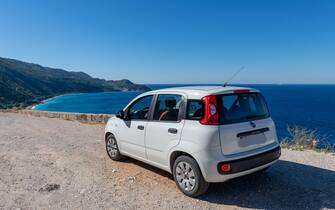 Fiat Panda Lefkada island. 10.15.2022. A Fiat Panda by a seaside location with a beautiful view of the sea and long sandy beach.