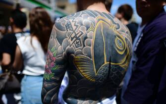 Participant with Japanese tattoo is seen in the street of Asakusa during Sanja Festival on May 19, 2019 in Tokyo, Japan. A boisterous traditional mikoshi (portable shrine) is carried in the streets of Asakusa to bring goodluck, blessings and prosperity to the area and its inhabitants. (Photo: Richard Atrero de Guzman/ NUR Photo) (Photo by Richard Atrero de Guzman/NurPhoto via Getty Images)