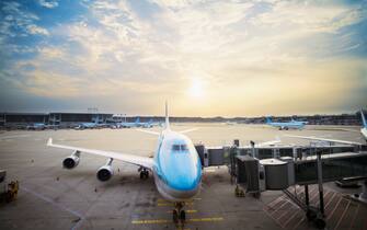 624855697 Airplane parked at gate at sunset at Seoul Incheon International Airport, South Korea