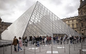 epa09211465 Visitors queue outside the Louvre Museum on its reopening day, in Paris, France, 19 May 2021. France eased some of its coronavirus disease (COVID-19) restrictions starting on 19 May, allowing cultural place, cinema, restaurants and cafes to admit customers outdoors, as pressure on hospitals and intensive care units in the country is diminishing.  EPA/YOAN VALAT