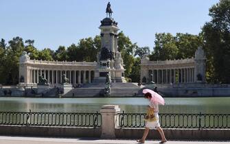 epa09365420 A woman walks in Retiro Park in Madrid, Spain, 25 July 2021, after the UNESCO added Madrid's historic Paseo del Prado boulevard and Retiro Park to its list of world heritage sites earlier on the day. Unesco World Heritage list committee decided the candidacy 'Landscape of Light', made up of the Paseo del Prado and the Buen Retiro park, would access the catalog in the category of the cultural landscape.  EPA/Mariscal