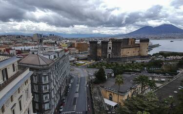 View of the empty street in Naples city, on backgound the Maschio Angioino Castle and Vesuvius, after the Italian government has imposed unprecedented national restrictions on controlling the coronavirus COVID-19.