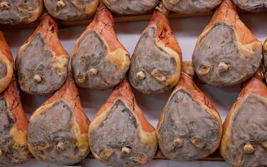 Europe, Italy, Tuscany, Greve in Chianti. Prosciutto hams hanging in a shop in the Tuscan town of Greve in Chianti.