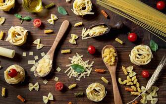 Various pasta on wooden background