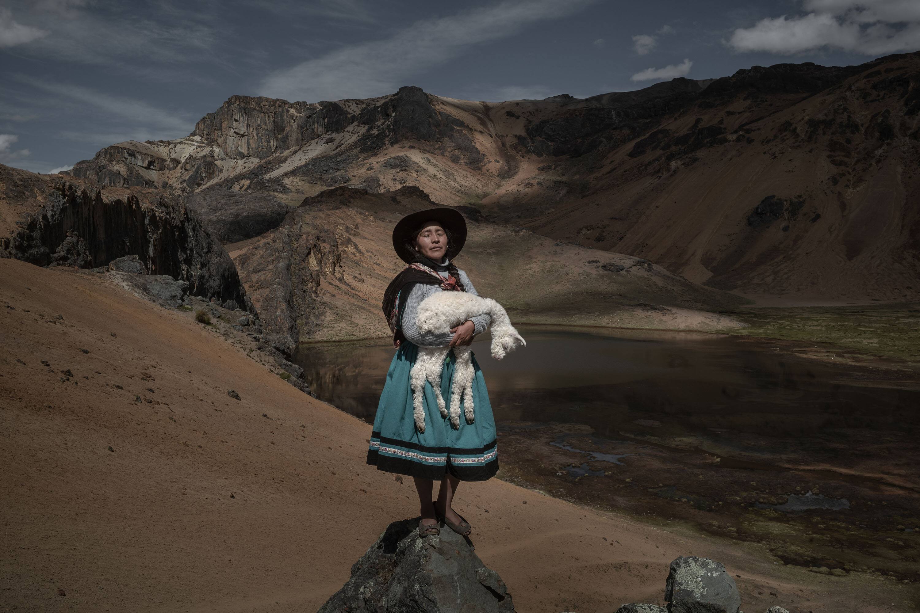 At an altitude of more than 5000 mt, in the Andes of southern Peru, Alina Surquislla Gomez, a third-generation Alpaquera, cradles a baby alpaca on her way to the pastures where her family’s herd of more than 300 animals will graze in summer. Shrinking glaciers and increased drought have dried pastures in the Andes, forcing the herders—many of whom are women—to search for new grazing grounds, often in difficult terrain. Prized for their wool, alpacas are important to Peruvian culture and a major source of income in this region, which is home to several million of them. In the interview, Surquislla Gomez says: " When I was little, my grandfather used to tell me how beautiful it was to graze in these valleys, due to climate change the situation has changed, we can no longer live like before and I am forced to make many sacrifices, but this is my life and my work and thanks to this I am able to support my children."